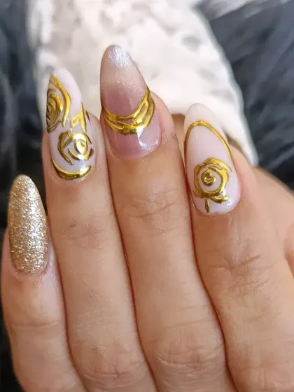 A different angle of the sculpted gold rose design, showcasing the texture and shine of the metallic art.