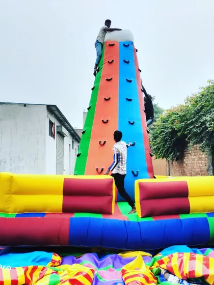 People actively using our 16x16 feet, four-sided inflatable climbing tower. This design allows multiple climbers at once, making it efficient for handling crowds at events.
