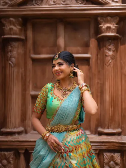 A happy, smiling portrait against the same wooden door. The bride's joyful expression is contagious and brings the photo to life.