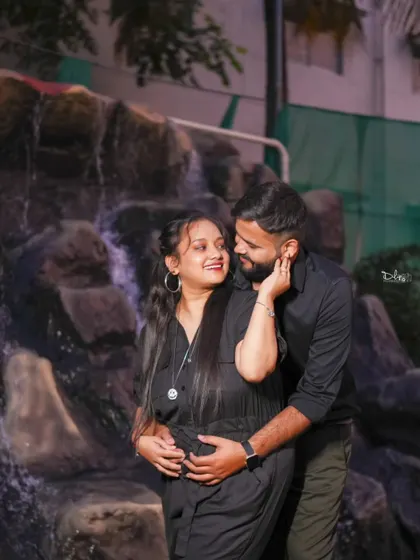 A lovely maternity photo of a couple by a waterfall feature. I capture the anticipation and joy of this special time.
