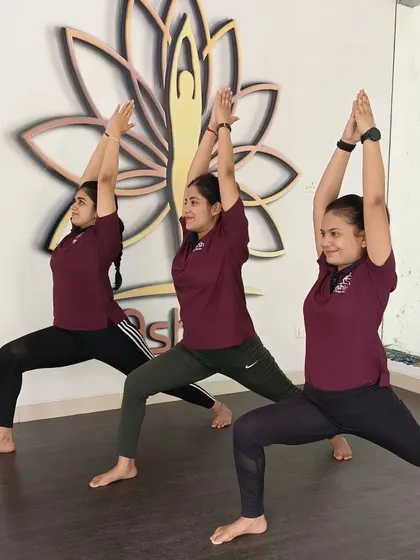 Our instructors demonstrate Virabhadrasana I (Warrior I) in perfect unison.