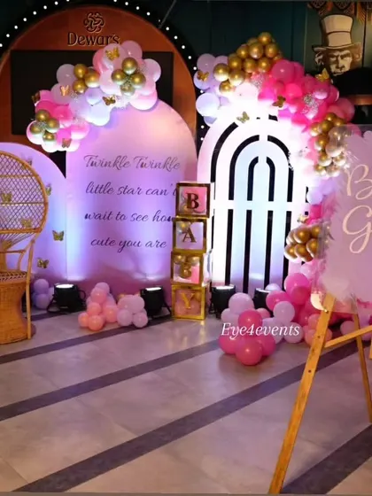 A dreamy "Twinkle Twinkle Little Star" baby shower. We used a soft lavender and pink color palette with backlit backdrops, a wicker peacock chair, and a custom sign to create a magical and ethereal atmosphere for the mom-to-be.