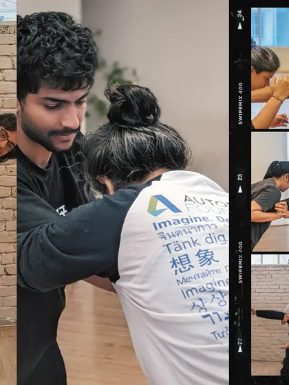 An instructor provides hands-on guidance during a partner stretching exercise, ensuring proper technique and safety.
