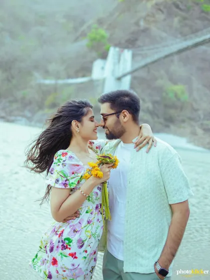 An intimate close-up of a couple on a windy beach in Rishikesh, their hair blowing in the wind as they share a moment.