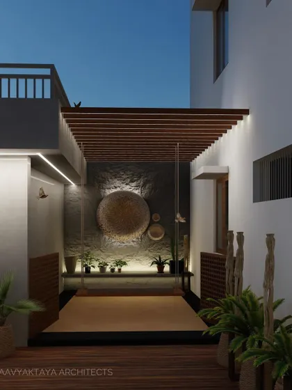 This design for an outdoor courtyard features a large, suspended swing bed, perfect for relaxing. The space is defined by a textured stone accent wall, a wooden pergola, and natural plantings, creating a private oasis that thoughtfully blends architecture and landscape.