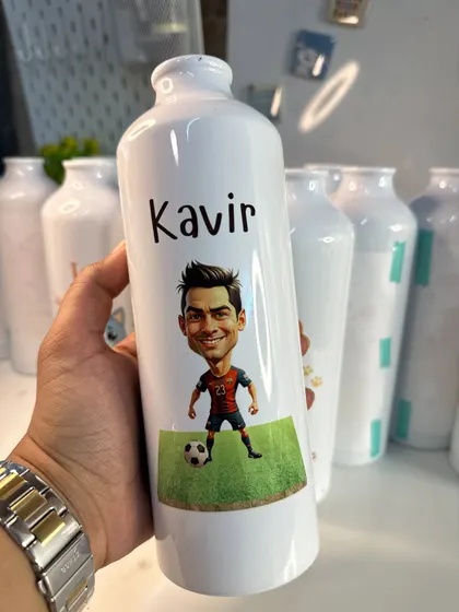 Get your bottle personalized with a fun caricature. This one features a football player design with the name 'Kavir'. I offer great deals on bulk orders for return gifts.