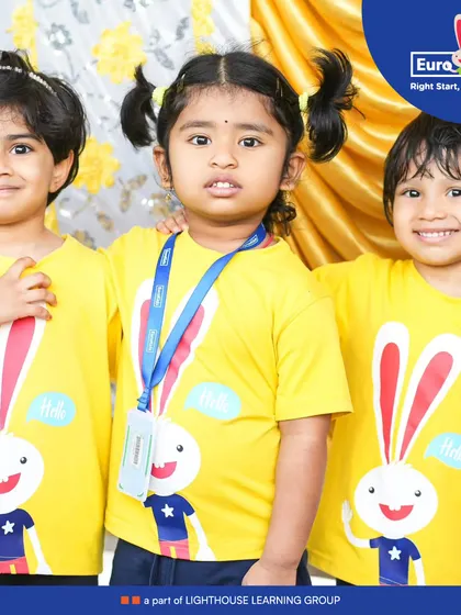Three friends in matching yellow shirts pose together, showcasing the camaraderie and fun of our school events. These moments of friendship are just as important as the activities themselves.