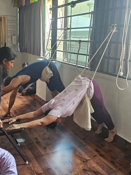 Finding length and release in Ardha Mukha Svanasana (Downward-Facing Dog) with the help of ropes, a classic Iyengar-inspired technique.