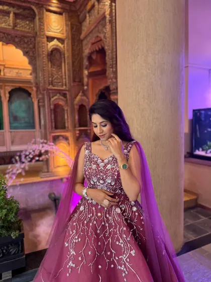 The intricate silver embroidery on this wine-colored ball gown sparkles beautifully. It's a sophisticated and elegant choice for any formal celebration.