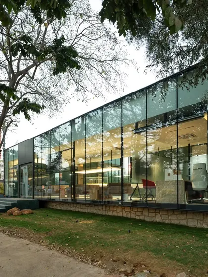 We make boxes. This is the VPG Experience Center, a simple, rectilinear form that is all about transparency and connection to the outdoors. The full height glass walls reflect the surrounding trees, blurring the line between inside and out.