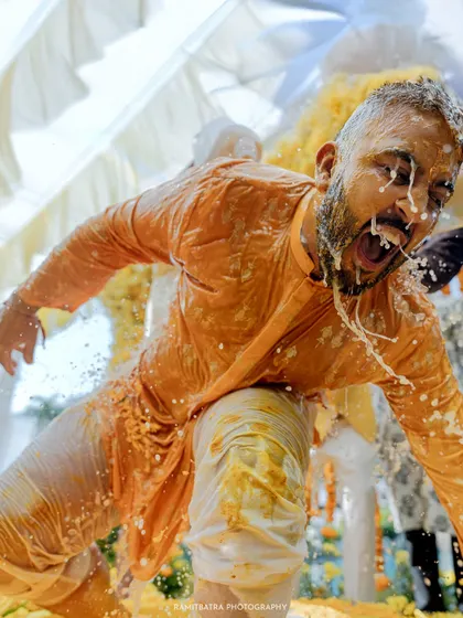 The groom is joyfully drenched during a wild Haldi ceremony in Hua Hin, Thailand. This is the kind of candid, high-energy moment I live to capture, where everyone's guards are down and the celebration is pure, unadulterated fun.