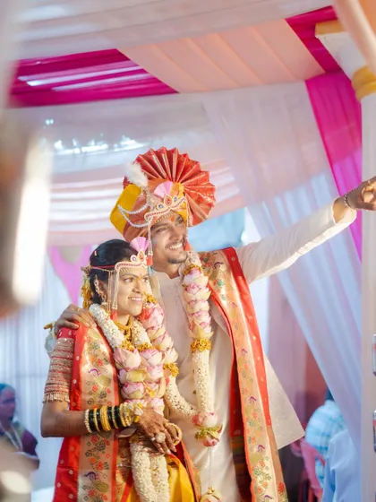 A candid moment during the ceremony, with the groom pointing towards the future, his arm around his bride.