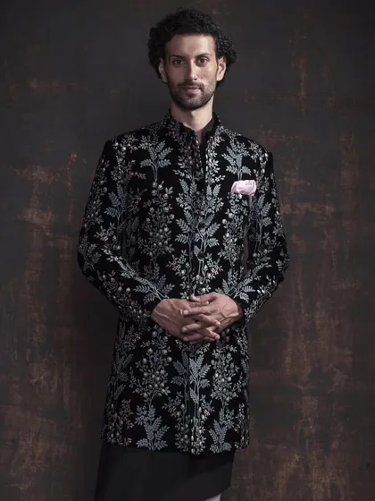 An example of modern ceremonial wear. This black bandhgala jacket is crafted from rich velvet and features intricate floral embroidery. It’s a piece that balances traditional Indian elegance with a sharp, contemporary silhouette for a truly memorable look.