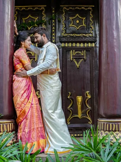 A romantic pose for a couple in traditional South Indian attire in front of our ornate dark wood pillars.