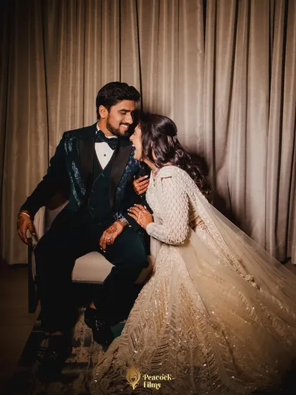 A sweet, candid moment between the couple during their Sangeet. The bride's joyful laugh and their close embrace create a heartwarming portrait.
