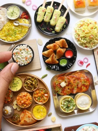 A wonderful display of recent miniature orders, featuring samosas, kulfi, thalis, and more.