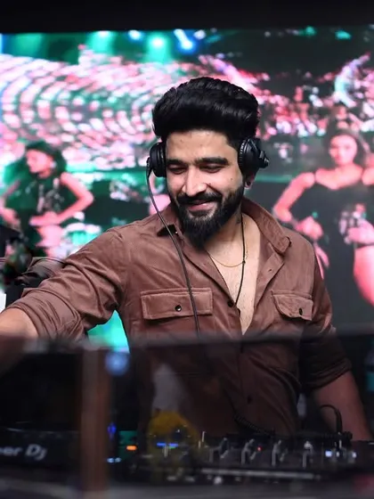 My sets are a full sensory ride. Here I am at Hex Mumbai, mixing tracks while the LED screen behind me shows dancers, creating a dynamic visual backdrop for the music.