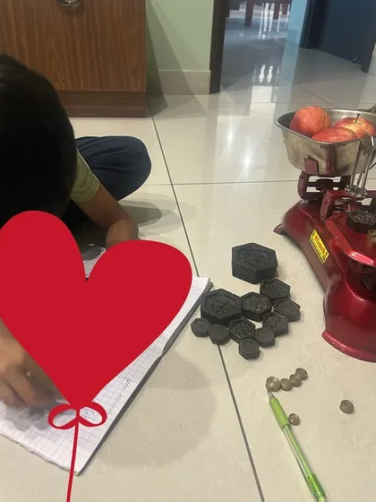 After experimenting with the scales, it's time to record the findings. This step connects the concrete, hands-on experience to the abstract representation of numbers and equations, bridging the gap between doing and documenting.