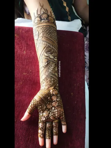 A full-arm design with a focus on flowing, organic patterns. The paisleys and vines create a sense of movement up the arm.