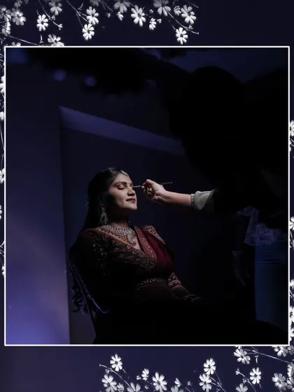 A behind-the-scenes shot of the bride getting her makeup done for the reception.