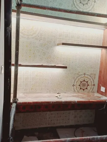 Executing complex designs is our specialty. This photo shows our team carefully working on an intricate, multi-layered stencil pattern in a double-height space, showcasing the precision and care we take with every project, no matter the scale.