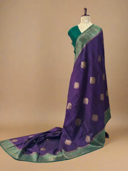 A stunning pure Dupion Banarasi silk saree in purple with a contrasting green border and gold butis.