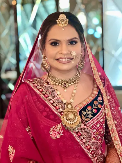A close-up of the bride's radiant smile. The makeup is designed to enhance her happiness and glow from within.