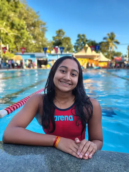 Kiarah Huidrom smiling by the pool.