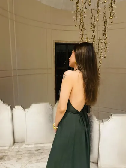 Another angle of the green dress, showing the flowy fabric and elegant silhouette.