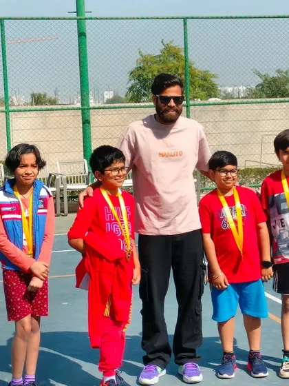 A group of young champions showing off their medals after giving their all on the court.
