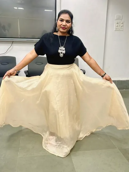Another modern Navratri look. A simple black top paired with a flared cream-coloured skirt.