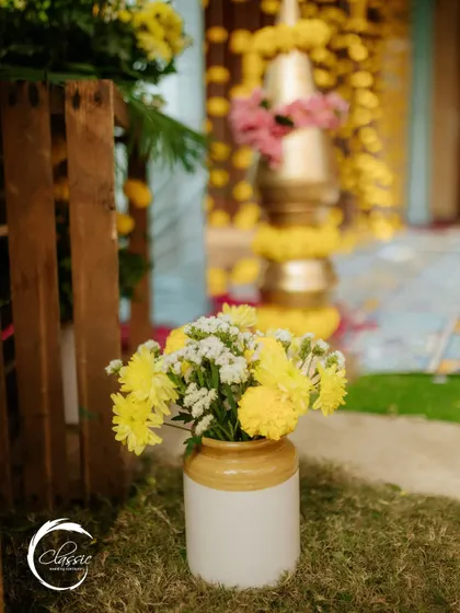 Small touches make a big difference. A simple ceramic pot with yellow chrysanthemums adds a spot of charm and continues the color theme throughout the venue.