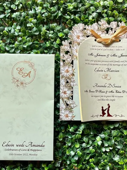 A beautiful Christian wedding invitation with a delicate laser-cut frame of daisies. The design is elegant and timeless, perfect for a church ceremony.