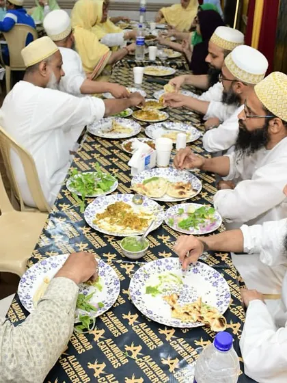 Guests from the Bohra community enjoying their meal together. The communal style of dining is at the heart of the thaal experience.