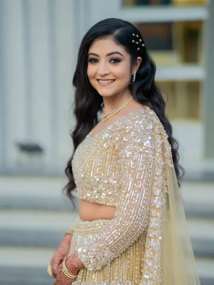 A happy, smiling bride. Her makeup looks fresh and radiant, perfect for her reception.