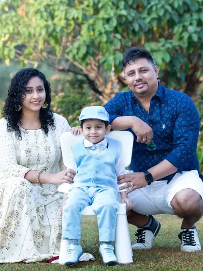 A classic family portrait with mom, dad, and their smartly dressed little boy. The natural outdoor setting provides a beautiful, timeless backdrop.