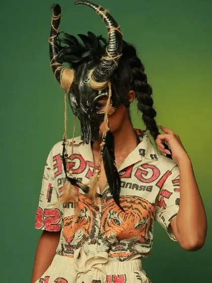 An avant-garde shot for Diseno.in, using a dramatic mask and tribal-inspired styling to create a memorable and artistic image.