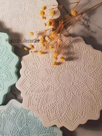 Our Mandala coasters bring a touch of intricate detail to your coffee table. This photo shows a variety of pastel shades, each with the same beautiful, calming pattern.