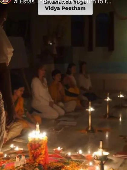 Students gathered for a lamp-lighting ceremony. The light from the diyas symbolizes the inner light of consciousness that we seek to realize through our practice.
