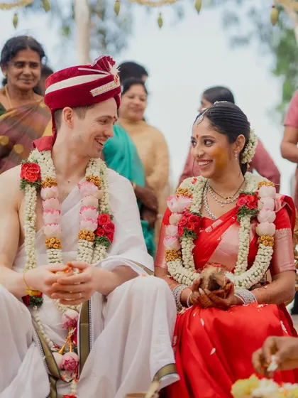 A candid moment of shared laughter between the bride and groom during their South Indian wedding ceremony. These unscripted moments are often the most cherished.