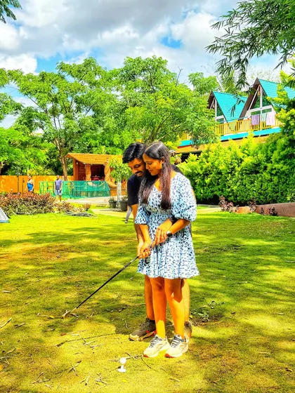 A couple tries their hand at outdoor golf on our lawns. It's a fun and lighthearted activity to enjoy together.