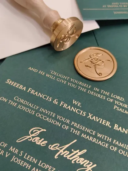 A close-up of the custom gold wax seal, adding a touch of timeless elegance and a personal signature to the invitation suite.
