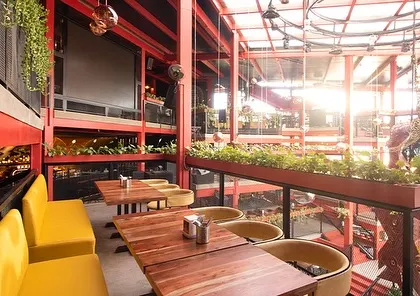 Inside Big Pitcher, planters are used along the railings of the multi-level space. This brings nature to every floor, ensuring that all guests have a view of greenery, which enhances the dining and social experience.