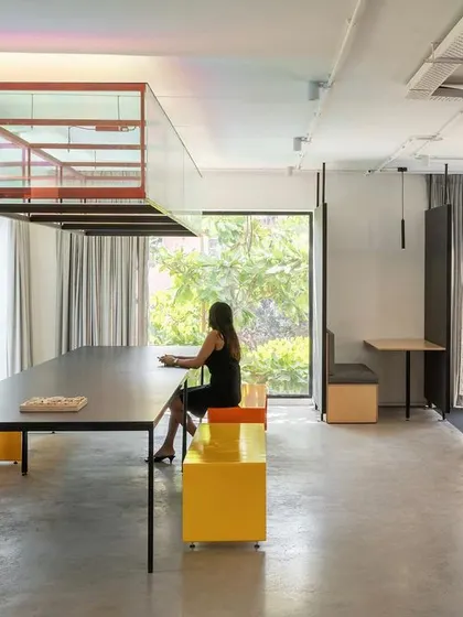 The Community Table in Studio 2.0, designed for informal meetings and vendor discussions. We added an iridescent light installation and our own colorful benches to create a space that is informal but still focused, encouraging creative and productive conversations.