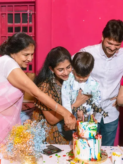 A heartwarming moment as the birthday boy and his family cut into the colorful cake that all the kids helped decorate.