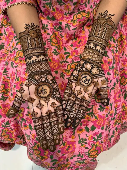 A personalized engagement mehndi design incorporating the couple's initials 'AS' and 'CG' into the central mandalas. This is a wonderful way to make your mehndi unique to your love story.