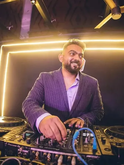 A candid shot of me spinning tracks at the NYE 2023 event. You can see the energy and focus that goes into crafting the perfect party set.