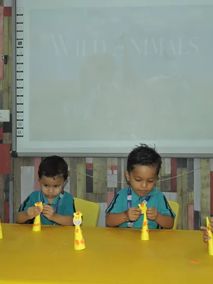 Little hands are busy creating giraffe crafts. We use art to reinforce lessons about the animal kingdom, making learning a creative and hands-on process.