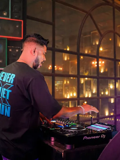 In the mix at Bombay Adda Bangalore. The warm, ambient lighting of the club creates an intimate yet energetic setting.