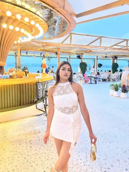 A confident walking pose inside the stunning beach club.